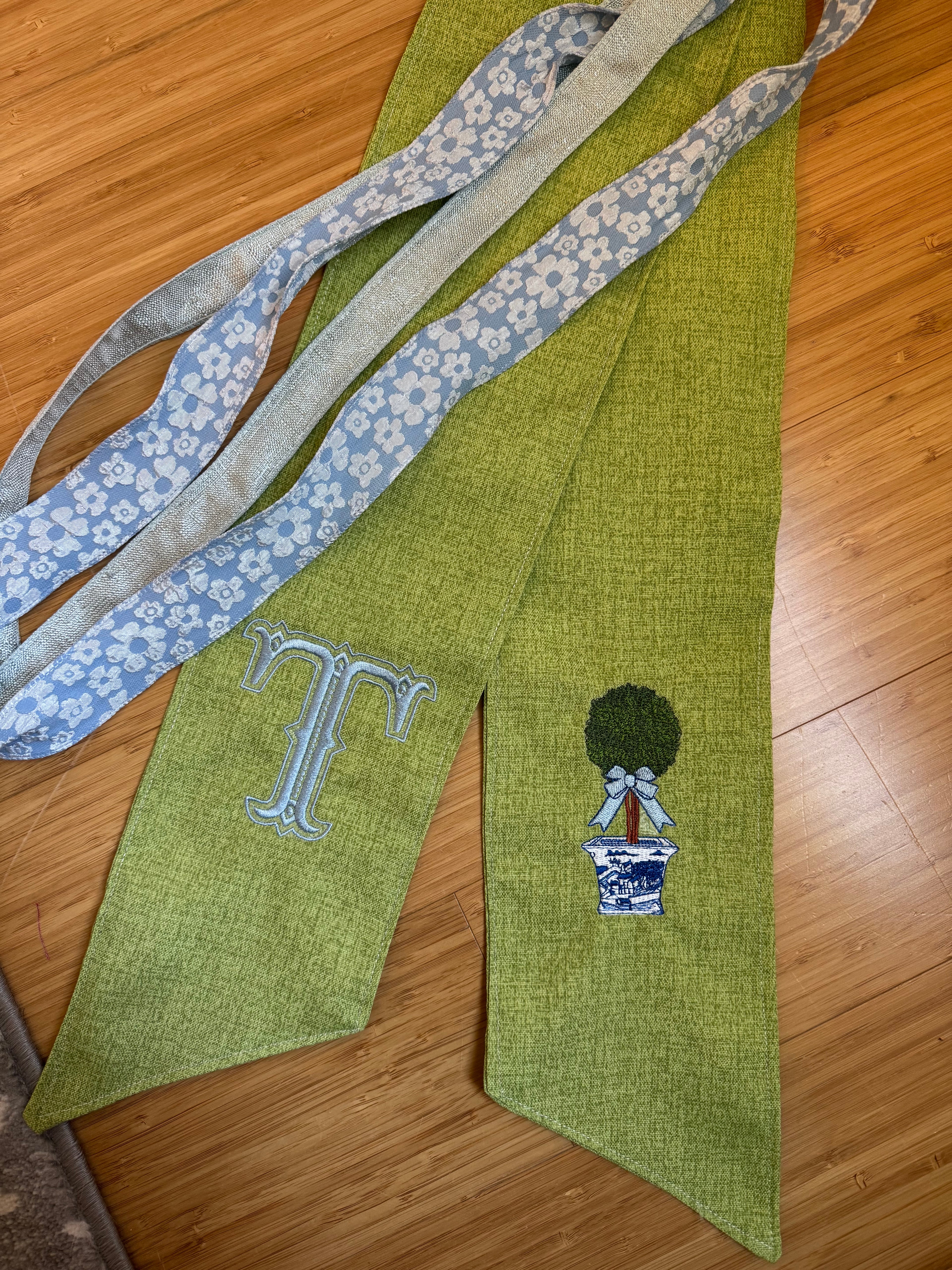 Boxwood Initial Wreath Sash on Green Fabric